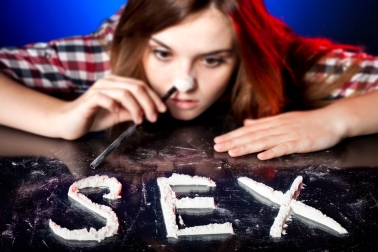 Woman snorting cocaine or amphetamines, symbol of sex addiction